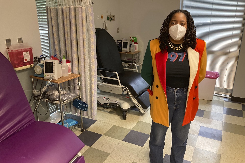 foster youth abortion access: medical worker stands in medical room with facemask on