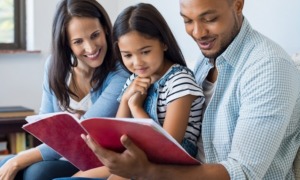 family literacy program grants: happy family reading a book together