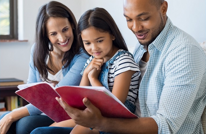 family literacy program grants: happy family reading a book together