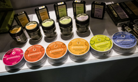 Marijuana packaging: Several colorful tins, jars and bozes lined up on a countertop