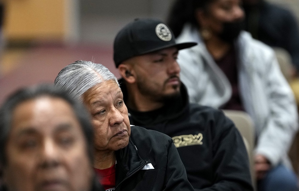 Native Americans share trauma of Arizona boarding schools: row of people sitting and looking off to the side