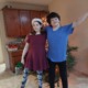 Nevada gave away $5 million to children with disabilities: two happy youth with disabilities side-hugging in front of Christmas tree