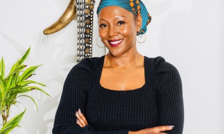 Q&A_Monique Couvson on why philanthropy should cede power to girls of color: black woman with colorful head scarf and dark shirt smiling with arms folded