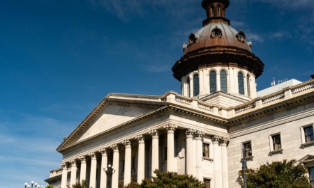 SC committee advances limits to classroom teaching on race: South Carolina state house building against blue sky