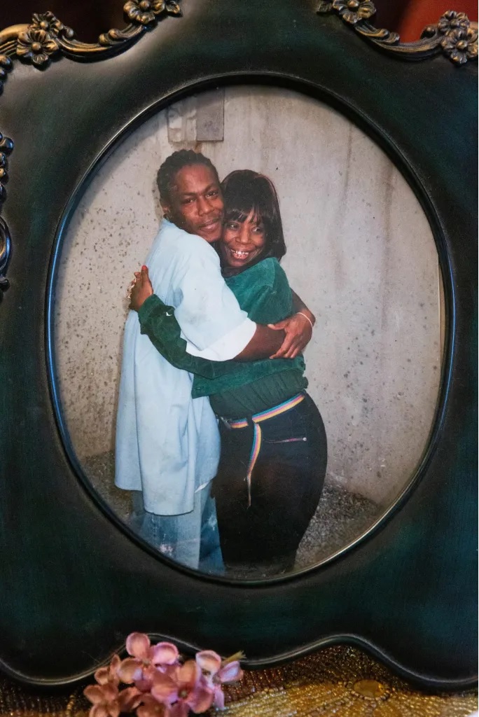 toll of his absence; women supporting prisoner Almeer Nance: old photograph of black man and woman hugging and smiling