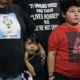 Uvalde families press urgency after California shootings: young boy hugging mother from the side while standing in group next to older boy