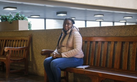Can Cleveland reduce harm eviction does to Black families: Black woman in jacket sits on bench