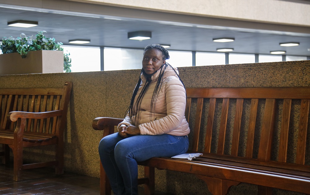 Can Cleveland reduce harm eviction does to Black families: Black woman in jacket sits on bench