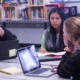 New England high school education innovation grants: group of young people at table on laptops discussing