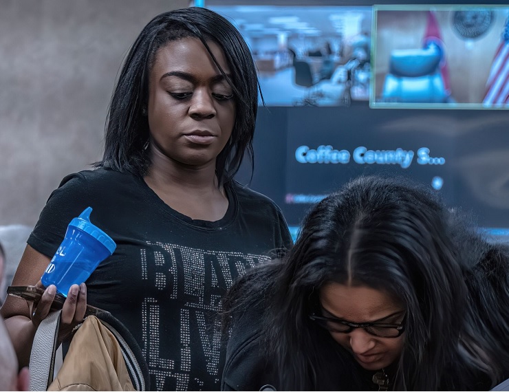 Kids taken from Black family remain in state custody: black woman looks down while holding a sippy cup