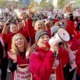 Los Angeles schools shut down for staff strike: group of people wearing red protests with one holding megaphone