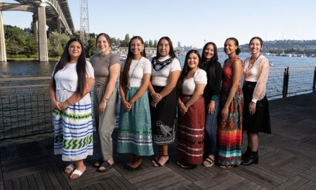 Native youth leadership program grants: group of young Native women standing in front of bridge and bay