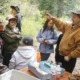Northwest Native-American community grants: group of youths learning about environment outdoors from educator