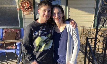Transgender youth: 'Forced outing' bills make schools unsafe: boy and his mother side-hugging on steps in front of house while smiling