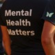 Social workers: Mental health toll unprecedented: view of person wearing black t-shit with "Mental Health Matters" on the back