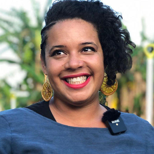Microschools: Headshot Black woman with short black, curly hair in blue top smiles into camera