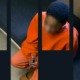 mass incarceration of children report: young black boy in orange jumpsuit sits in cell