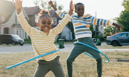 2023 KIDS COUNT data book: two black children hula-hooping happily