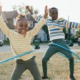 2023 KIDS COUNT data book: two black children hula-hooping happily