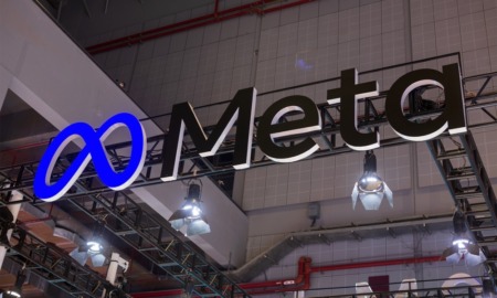 Meta logo: Meta in black lettering and logo from below in large building