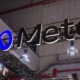 Meta logo: Meta in black lettering and logo from below in large building