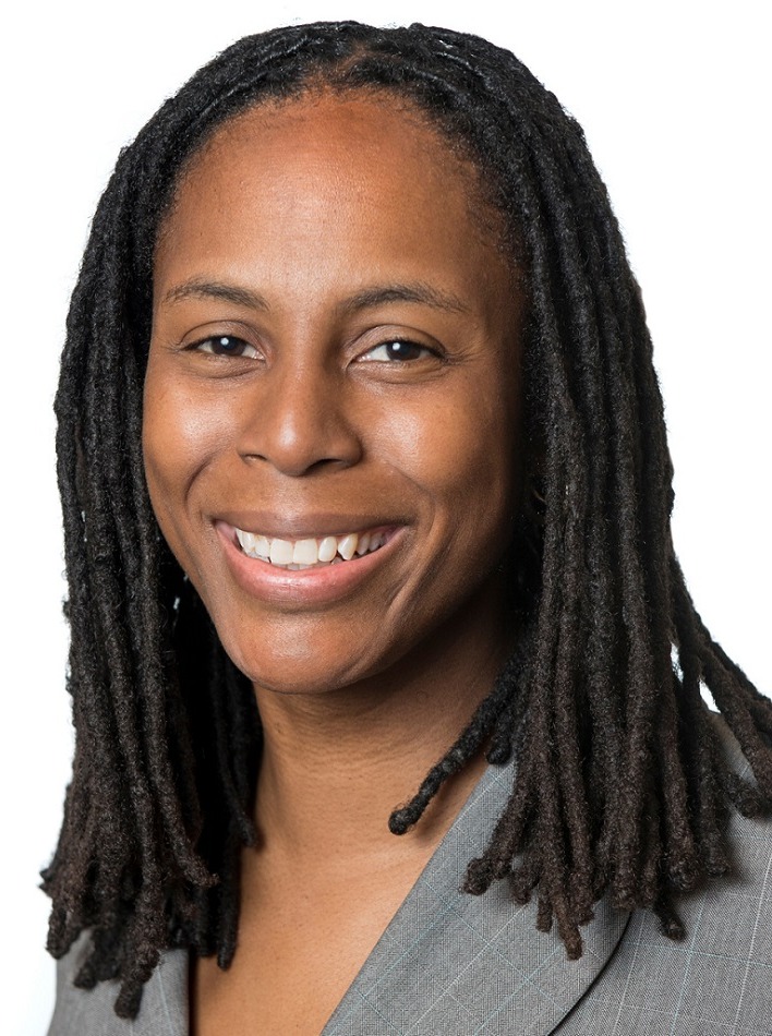 social media and youth mental health: Black woman with long hair smiling against white background