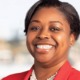 Dr. Gisele C. Shorter next president CEO of Nellie Mae: black woman with short hair and red blazer smiling