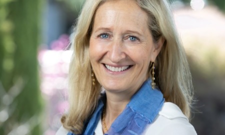 Stephanie Cornell executive director Walton Family Foundation: white woman with light hair in white shirt and blue scarf smiling outside