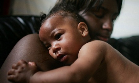 Grants for eliminating racial/ethnic disparities in perinatal health: black mother holds her baby lovingly
