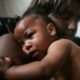Grants for eliminating racial/ethnic disparities in perinatal health: black mother holds her baby lovingly