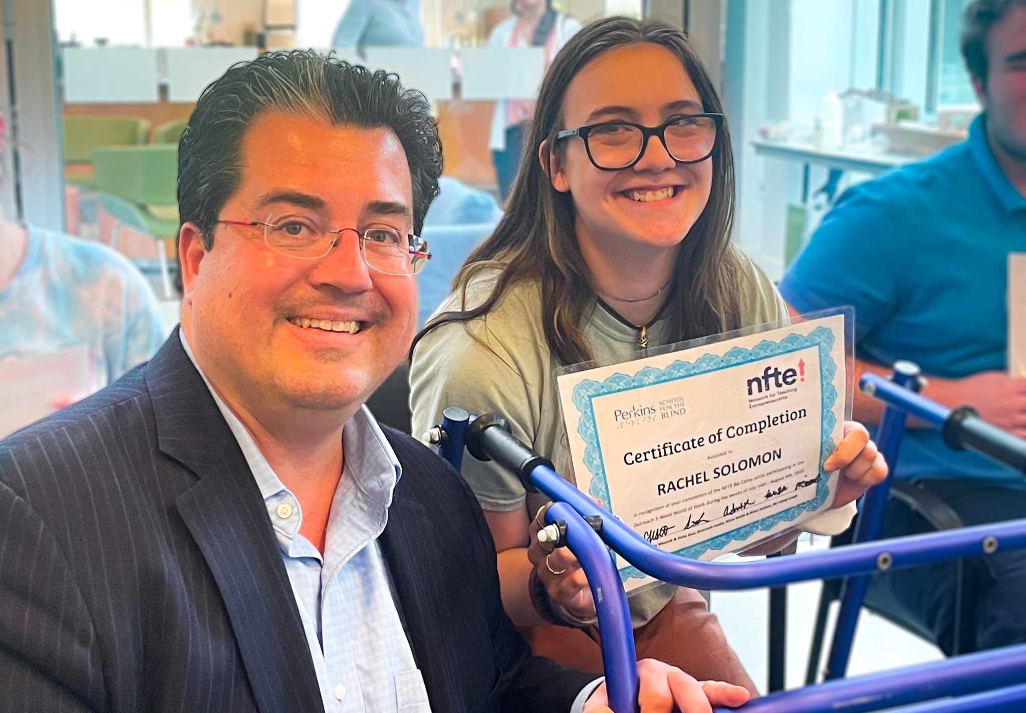 Rachel Solomon and J.D. LaRock: girl with long brown hair and glasses smiles while holding certificate next to man in glasses