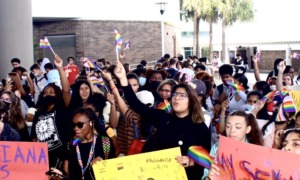 New Florida policy could out LGBTQ students to their parents: group of students with signs protesting