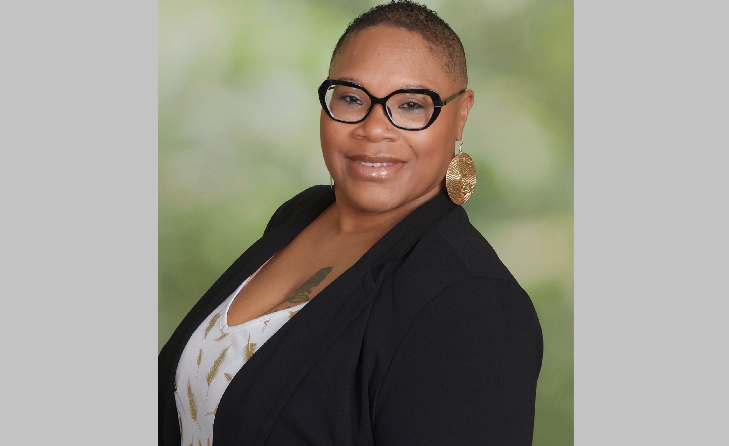Kimberly R Alexander executive director of MOBB United: black woman with short hair and glasses smiling in blazer