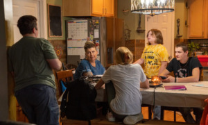 LGBTQ+ Clubs Kentucky: Family of five sits and stands around a kitchen table