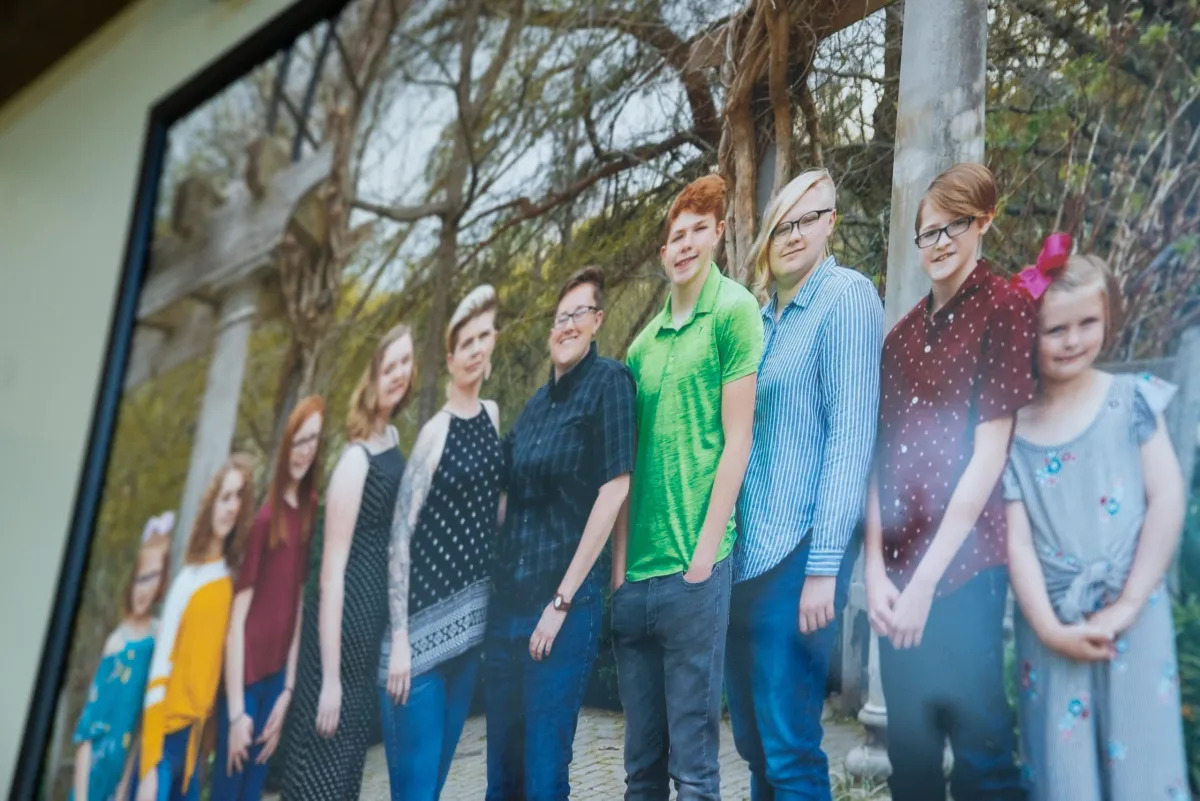 LGBTQ+ Clubs Kentucky: Close-up of framed photo of a family of 8 people standing in line for a family portrait