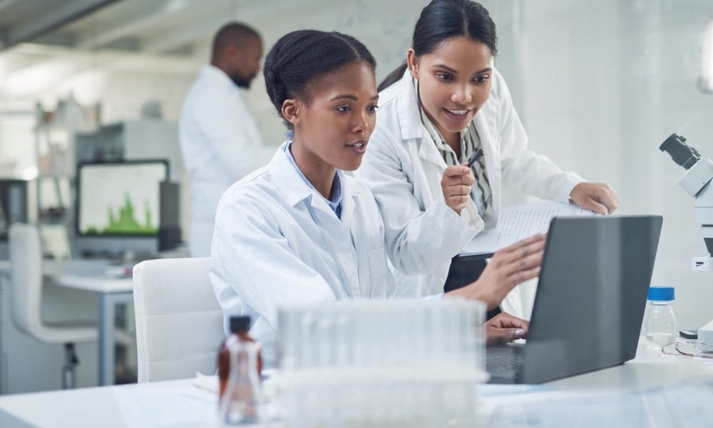 Disadvantaged students, increasing diversity in environmental health sciences: two young, females of color working in a lab setting looking at laptop