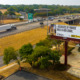 College campaign: Ariel view of freeway going through small town with billboard in foreground with image of person on left side and text "I discovered my purpose while in high school. MakeItMovement $60,000/year+"