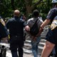 NYPD wrongly arresting black kids on Halloween: group of NYPD officers walking an arrested black youth across the street
