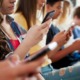 Teens, social media and technology 2023 report: line of teens looking at their phones