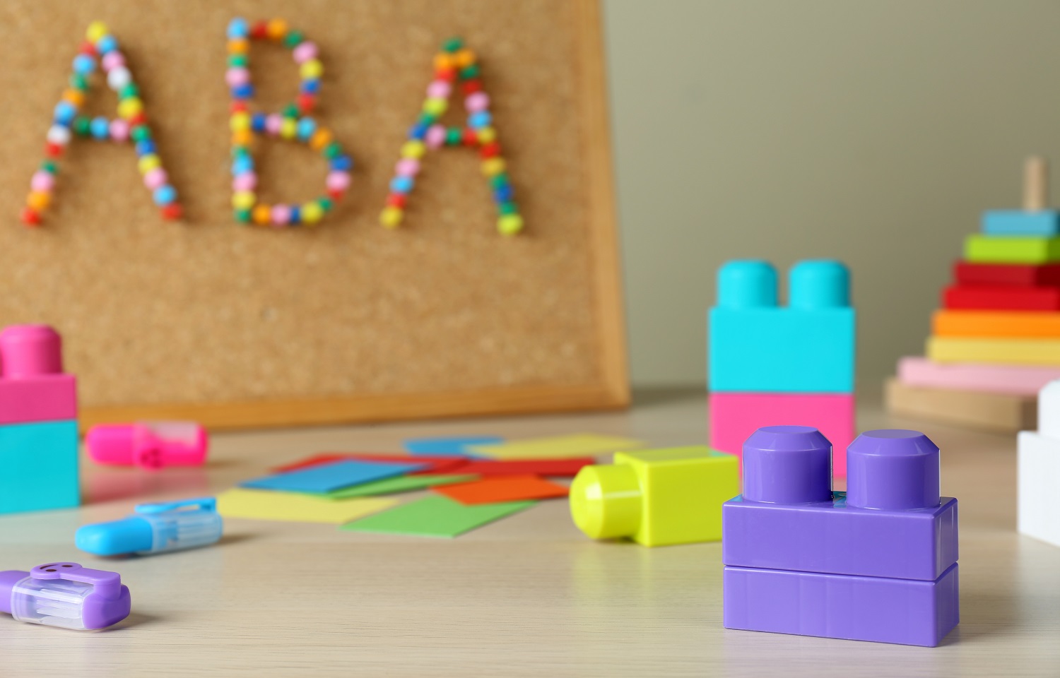 America’s most popular autism therapy may not work and may seriously harm patients’ mental health: cork board with "ABA" spelled out and colorful building blocks in foreground