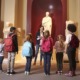 Education overhaul links kids to community spaces: young students and teacher at history museum