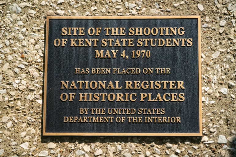 National Guard School Violence: Brass plaque with black background affixed to a tan pebble textured stone.