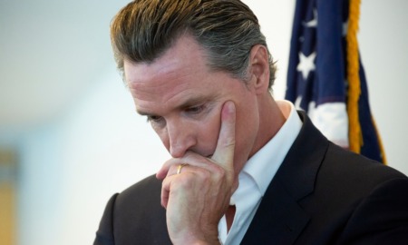 Newsom's aboutface raises homelessness risks for California's oldest foster care youth: white man in suit with head in hand looking down
