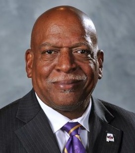 Chaplains in schools: Headshot Black man bald with white mustache in black suit with white shirt and purple striped tie