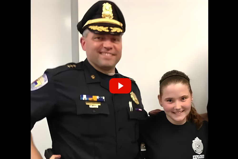 Sandra Birchmore justice: Young teen girl with brown hair pulled back stands smiling next to man in black police uniform and cap with hos arm around the girl's shoulders