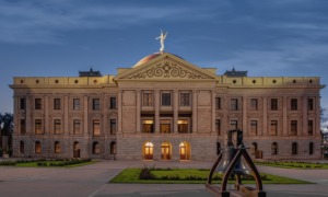 School vouchers supposed to save money, instead blew massive hole in Arizona budget: view of Arizona's state capitol building at dusk or dawn