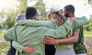 community progress and change grants, North Carolina Education: group of diverse people hugging in park