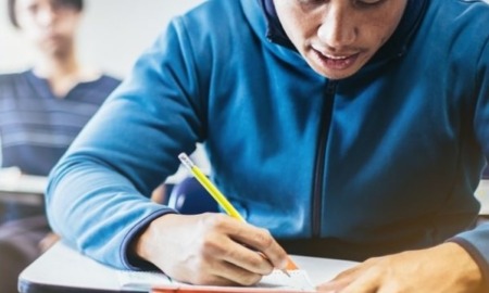 native tribal education grants: male student works at desk in school