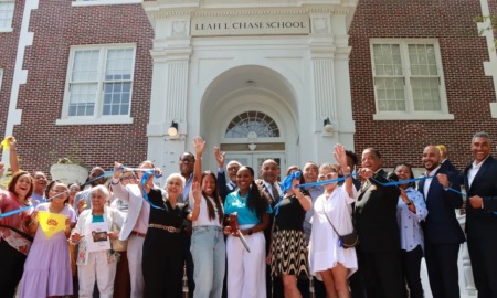 All charter no more_New Orleans opens first traditional school in nearly two decades: Group of people standing in front of school building and cutting ribbon