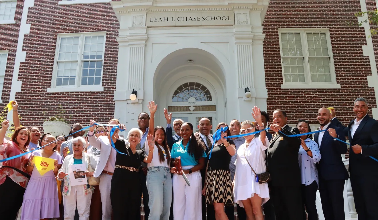 All charter no more_New Orleans opens first traditional school in nearly two decades: Group of people standing in front of school building and cutting ribbon